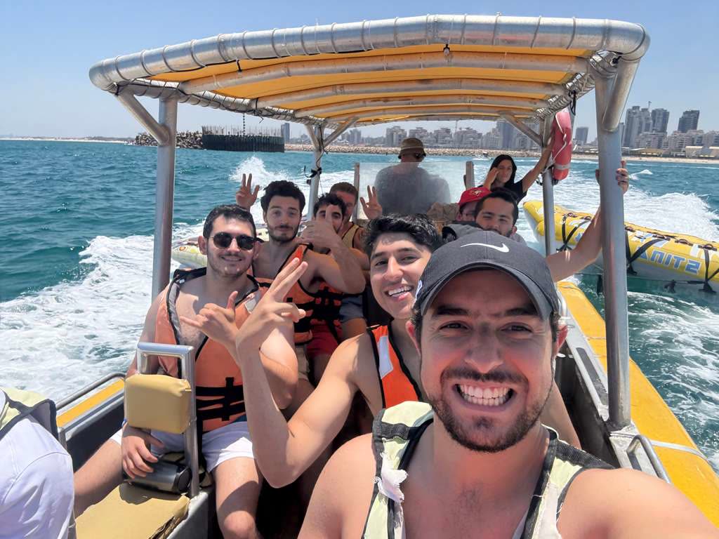 Rabbi Abergel and seven young men in life jackets on a speedboat off the Israeli coast.